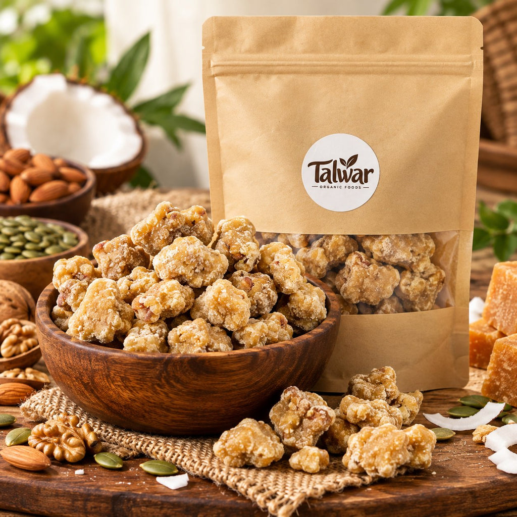 Organic dry fruit jaggery pieces in a wooden bowl with Talwar Organic Foods pouch