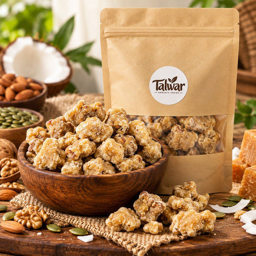Organic dry fruit jaggery pieces in a wooden bowl with Talwar Organic Foods pouch